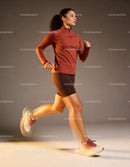 Focused female athlete running indoors in sportswear