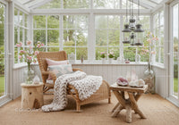 Cozy sunroom with wicker chaise and soft knit blanket