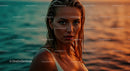 Young Woman in Sunset by Ocean with Water Droplets