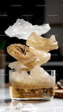 Suspended pieces of caramelized sugar and rock sugar over glass bowl