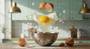 Fresh egg dropping into mixing bowl with sugar cubes