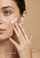 Close-up of a Woman Applying Skincare Lotion on Cheek for Beauty and Skin Care