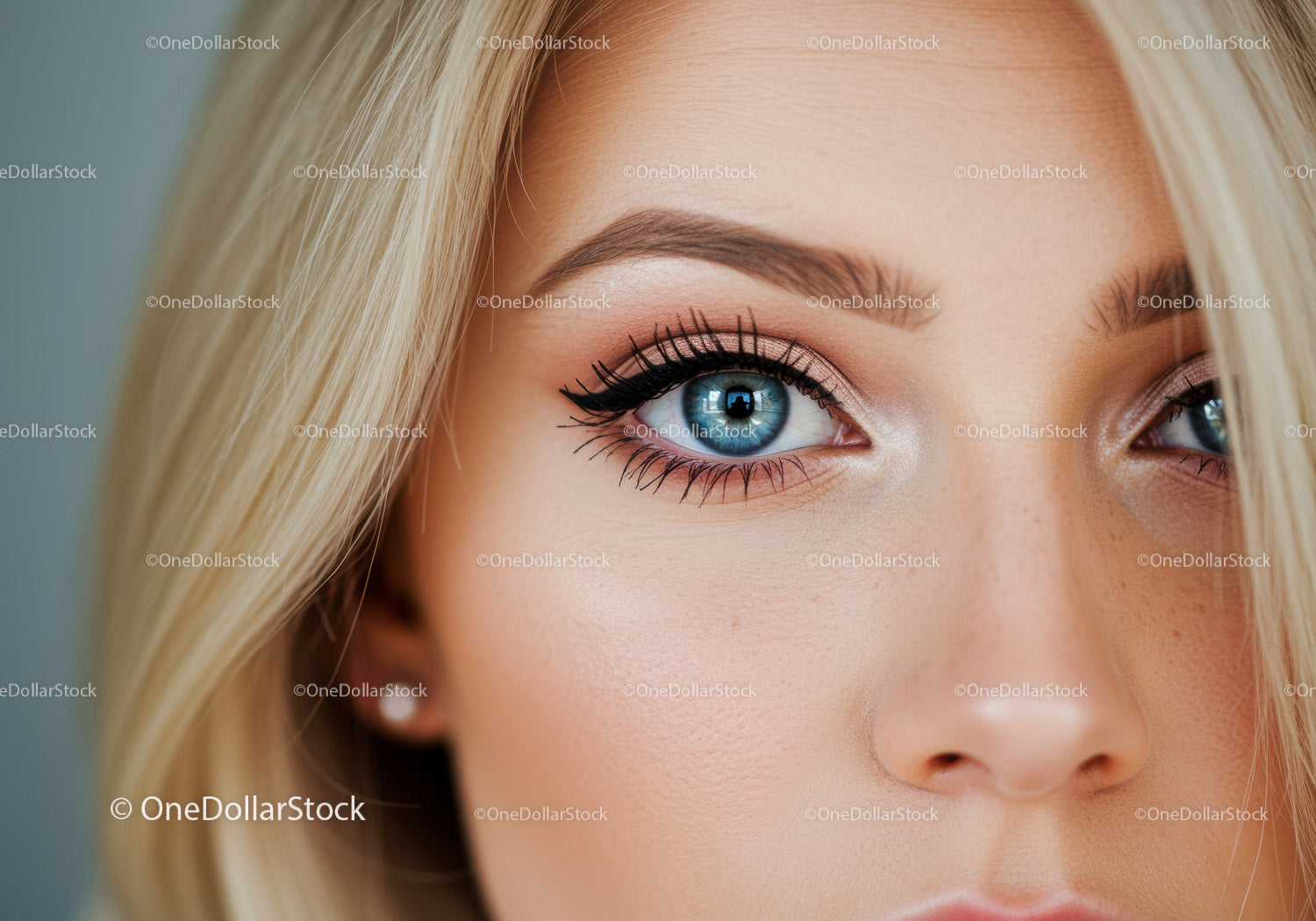 Close-up of blue eye with natural makeup on blonde face