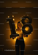 Young woman celebrating 18th birthday with glowing balloons