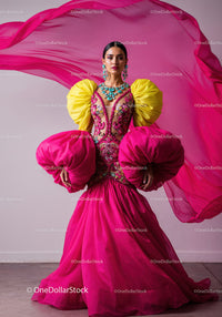 Fashion Model in Vibrant Pink and Yellow Flowing Gown