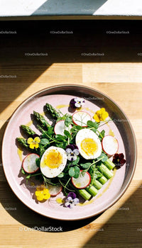 Fresh asparagus salad with soft boiled eggs and edible flowers