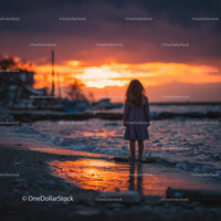 Silhouette of a Child at Sunset by the Ocean Shore