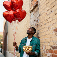Man Holding Heart Balloons and Chocolate Gift Box Outdoors