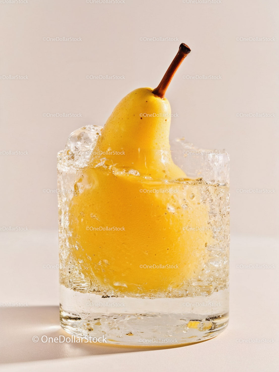 Whole yellow pear submerged in sparkling water glass