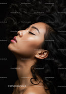 Profile of serene woman with curly hair and closed eyes