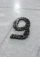 Ice hockey pucks arranged in number nine on rink