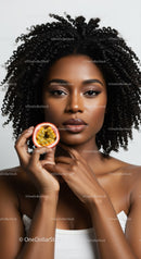 Portrait of a Beautiful Black Woman with Curly Hair Holding Passion Fruit
