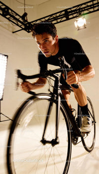 Focused Male Cyclist Training on Indoor Bike Trainer