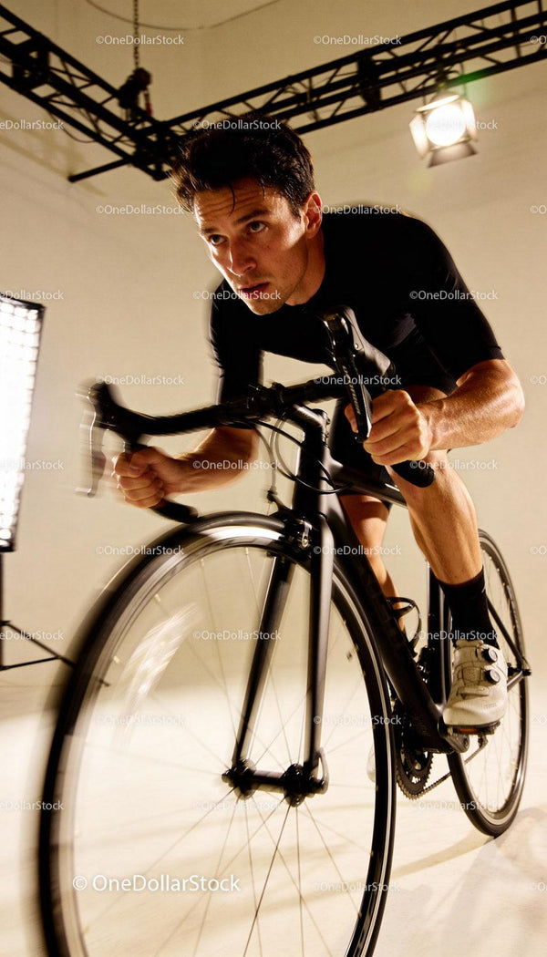 Focused Male Cyclist Training on Indoor Bike Trainer
