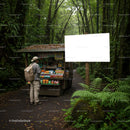 Traveler browsing snacks at forest roadside kiosk