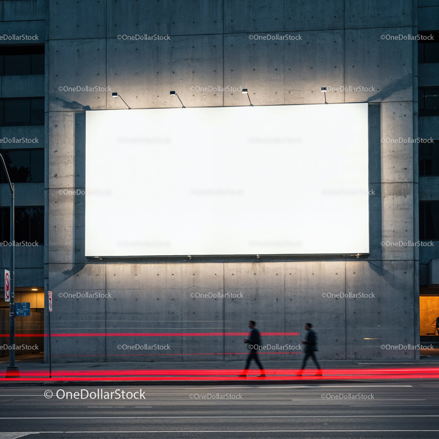 Two business people walking past illuminated blank billboard
