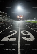Empty illuminated running track lane twenty nine at night
