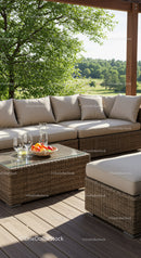 Elegant Outdoor Patio with Wicker Sofa and Scenic Greenery