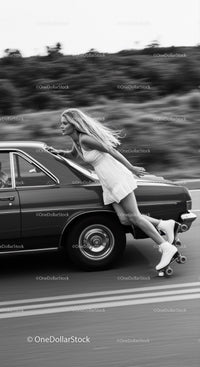 Woman in white dress roller skating beside car in motion