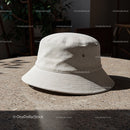 Minimalist beige bucket hat on textured table outdoors