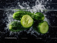 Fresh Cucumber Slices Splashing Water in a Dynamic Close-Up