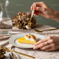 Lemon Tart with Meringue on Elegant Table with Floral Decor