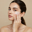Young Woman Applying Moisturizer for Flawless Skin