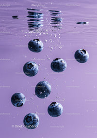 Fresh blueberries floating underwater in purple liquid