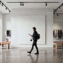 Person walking in modern minimalist clothing store interior