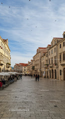 Charming European City Street with Historic Architecture and Outdoor Cafes