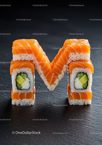Sushi rolls arranged in the shape of letter M