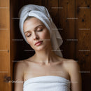 Relaxing Young Woman with Towel Wrap in Spa Setting