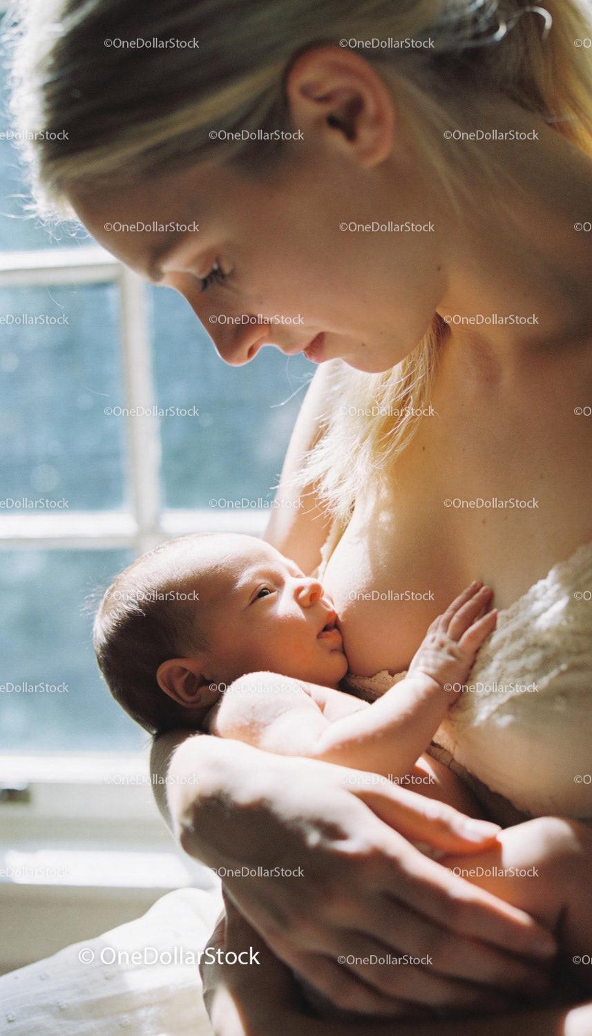 Tender moment of mother breastfeeding newborn baby