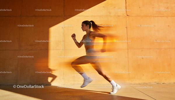 Female Athlete Sprinting with Motion Blur on Orange Wall