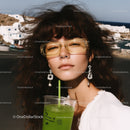 Stylish Woman with Curly Hair Wearing Sunglasses and Jewelry