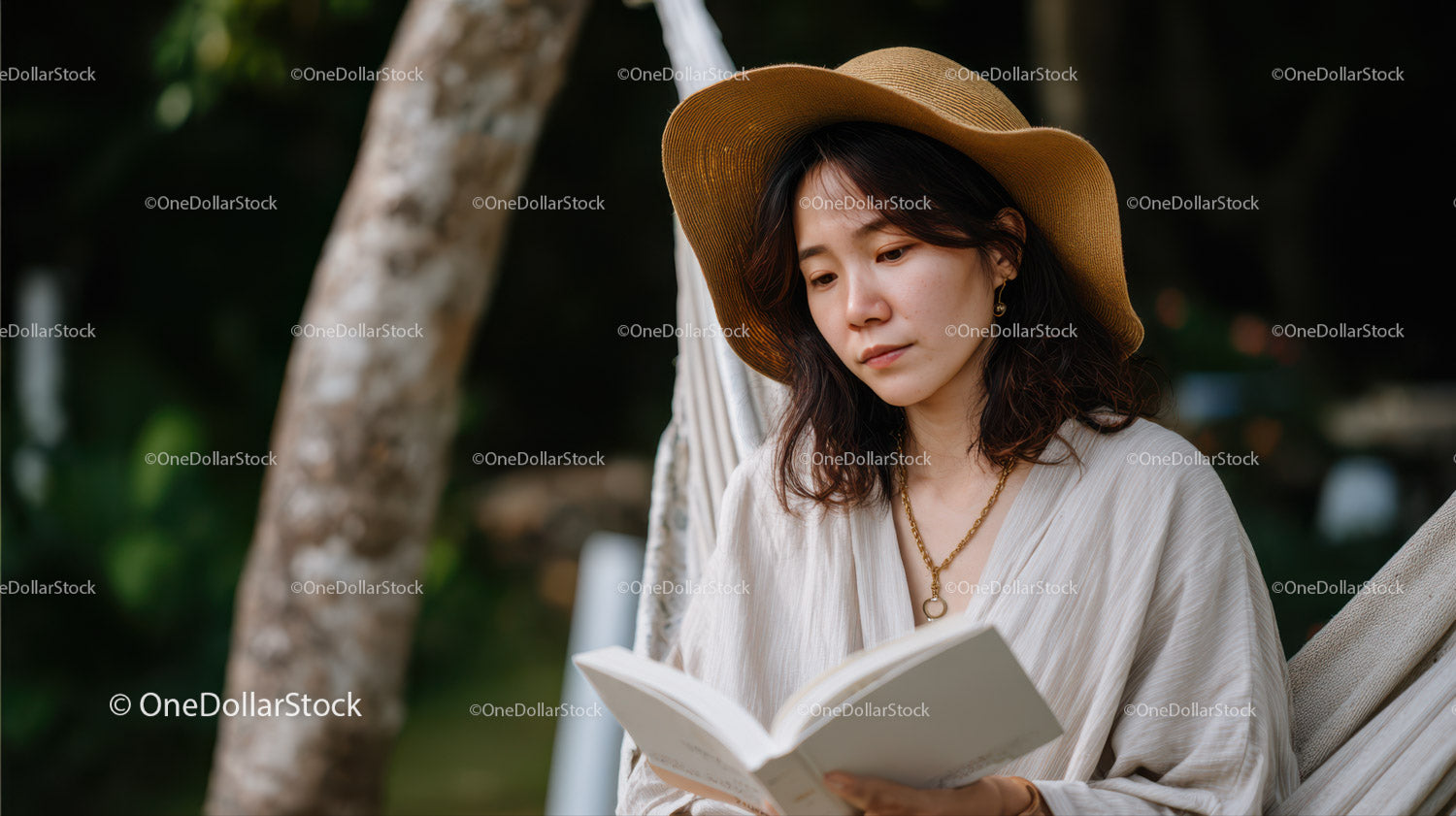 Woman Reading Book Outdoors Wearing Sun Hat in Tranquil Nature
