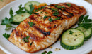 Grilled Fish with Cucumber Slices on Rustic Wooden Table