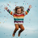 Joyful child jumping with colorful confetti in air