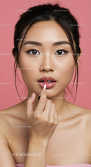 Young Woman Applying Lipstick with Perfect Makeup in Studio