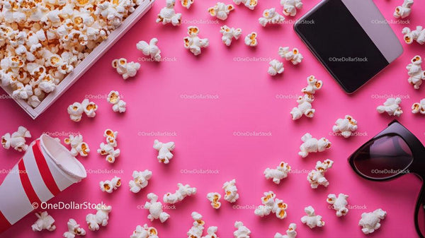 Popcorn, Smartphone and Sunglasses Scene on Bright Pink Background