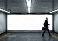 Businessperson Walking Through Underground Subway Tunnel in City