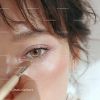 Close-up of Woman Applying Eye Makeup with Brush in Beauty Routine