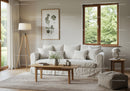 Cozy living room with white sofa and natural light