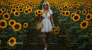 Woman in a Beautiful Sunflower Field Enjoying Summer Bliss
