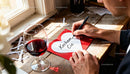 Man writing a heartfelt Valentine message by a window