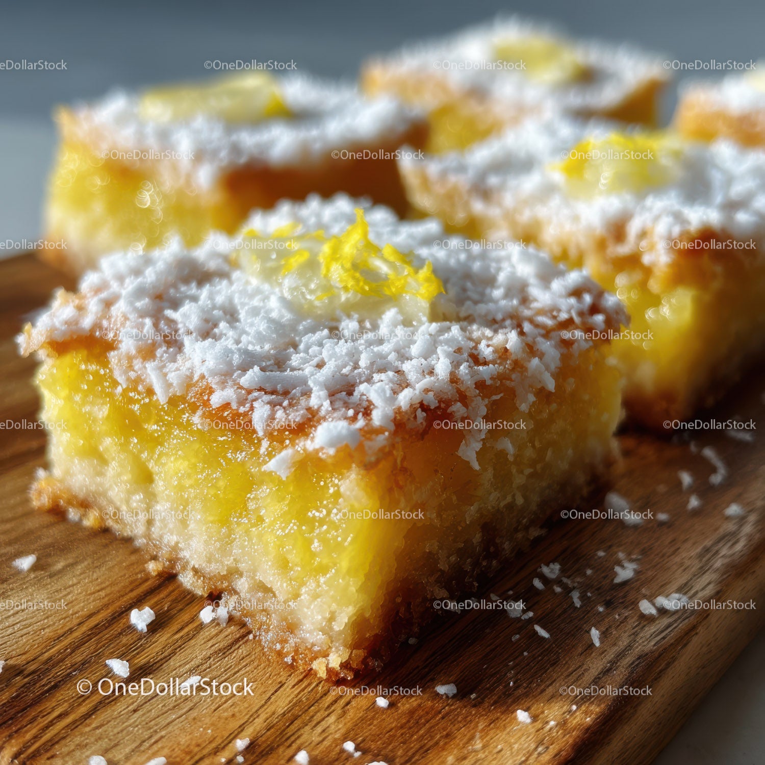Lemon Bars with Coconut Topping on Wooden Surface