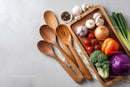 Assorted Fresh Vegetables and Wooden Utensils in the Kitchen