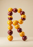 Letter R Formed by Fresh Apples and Oranges
