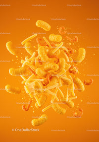 Bright assortment of cheese snacks against orange background
