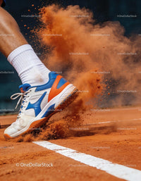 Tennis player sliding on red clay court foot closeup